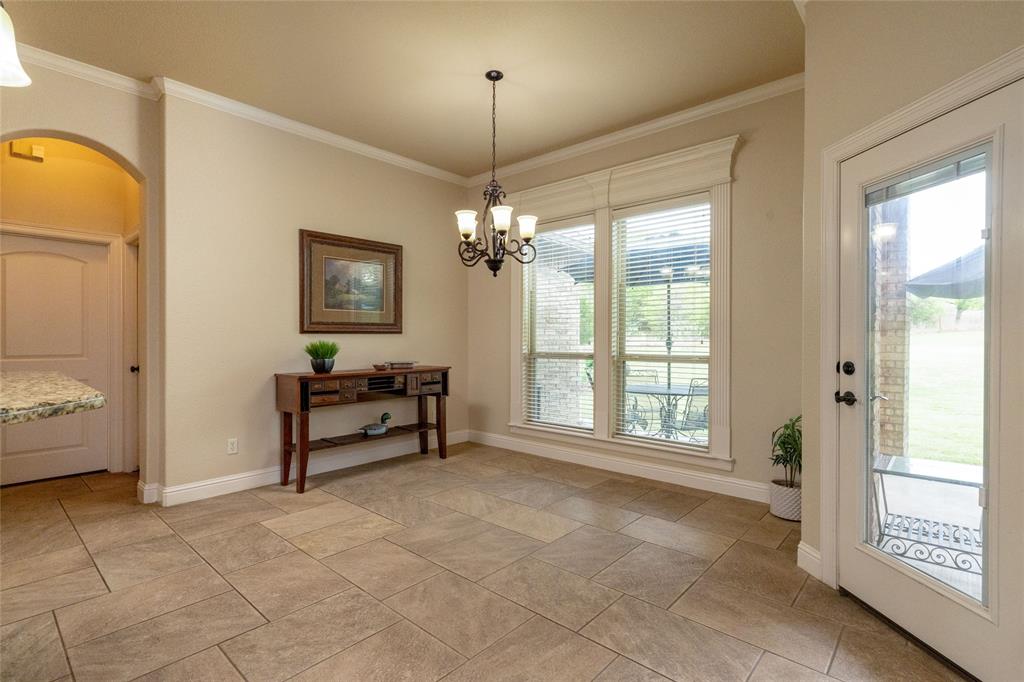 208 Ellis Creek Drive Weatherford, TX 76085 - Photo 22 of 40 Breakfast area can accommodate a table of 10, note the incredible crown molding that is absent with the newer homes. This home was completed in 2013