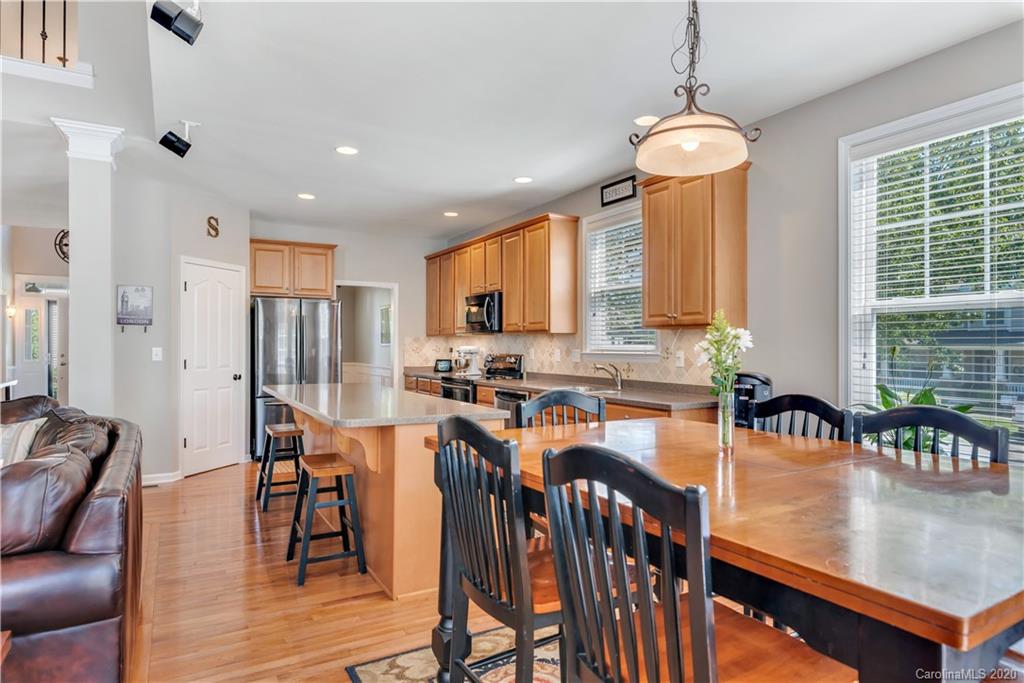 5303 Conant Circle Fort Mill, SC 29708 - Photo 13 of 37 a kitchen with stainless steel appliances granite countertop a table chairs refrigerator and sink
