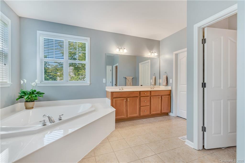 5303 Conant Circle Fort Mill, SC 29708 - Photo 16 of 37 a spacious bathroom with a tub sink and mirror