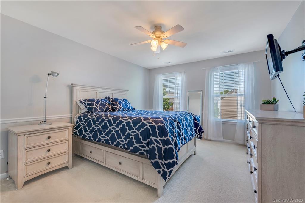 5303 Conant Circle Fort Mill, SC 29708 - Photo 23 of 37 a bedroom with a large bed and a chandelier