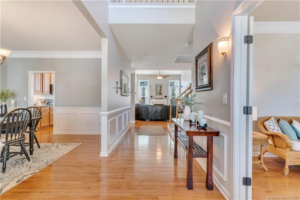 5303 Conant Circle Fort Mill, SC 29708 - Photo 5 of 37 a hallway with wooden floor table and chairs