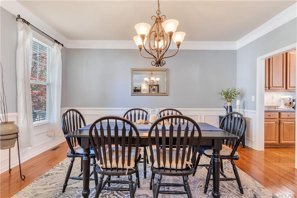 5303 Conant Circle Fort Mill, SC 29708 - Photo 7 of 37 a view of a dining room with furniture wooden floor and chandelier