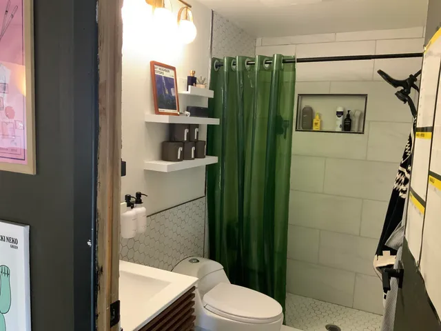 a bathroom with a toilet a sink and shower