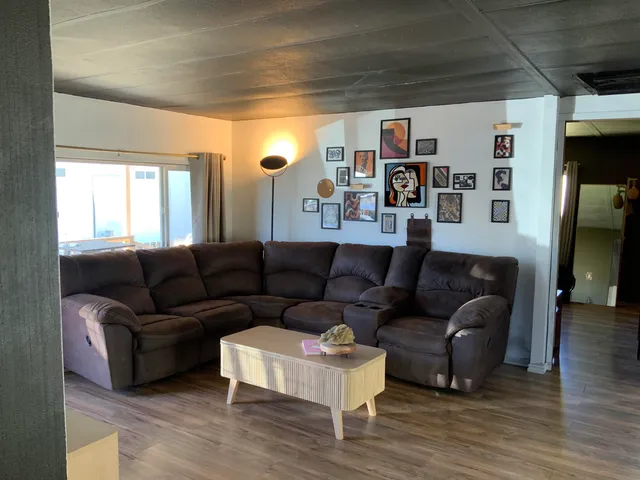 a living room with furniture and a bookshelf