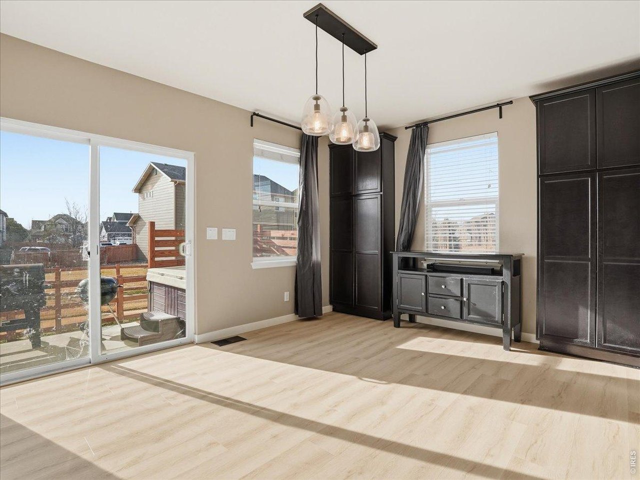 1565 Basildon Court Windsor, CO 80550 - Photo 15 of 36 a view of a livingroom with wooden floor and a ceiling fan