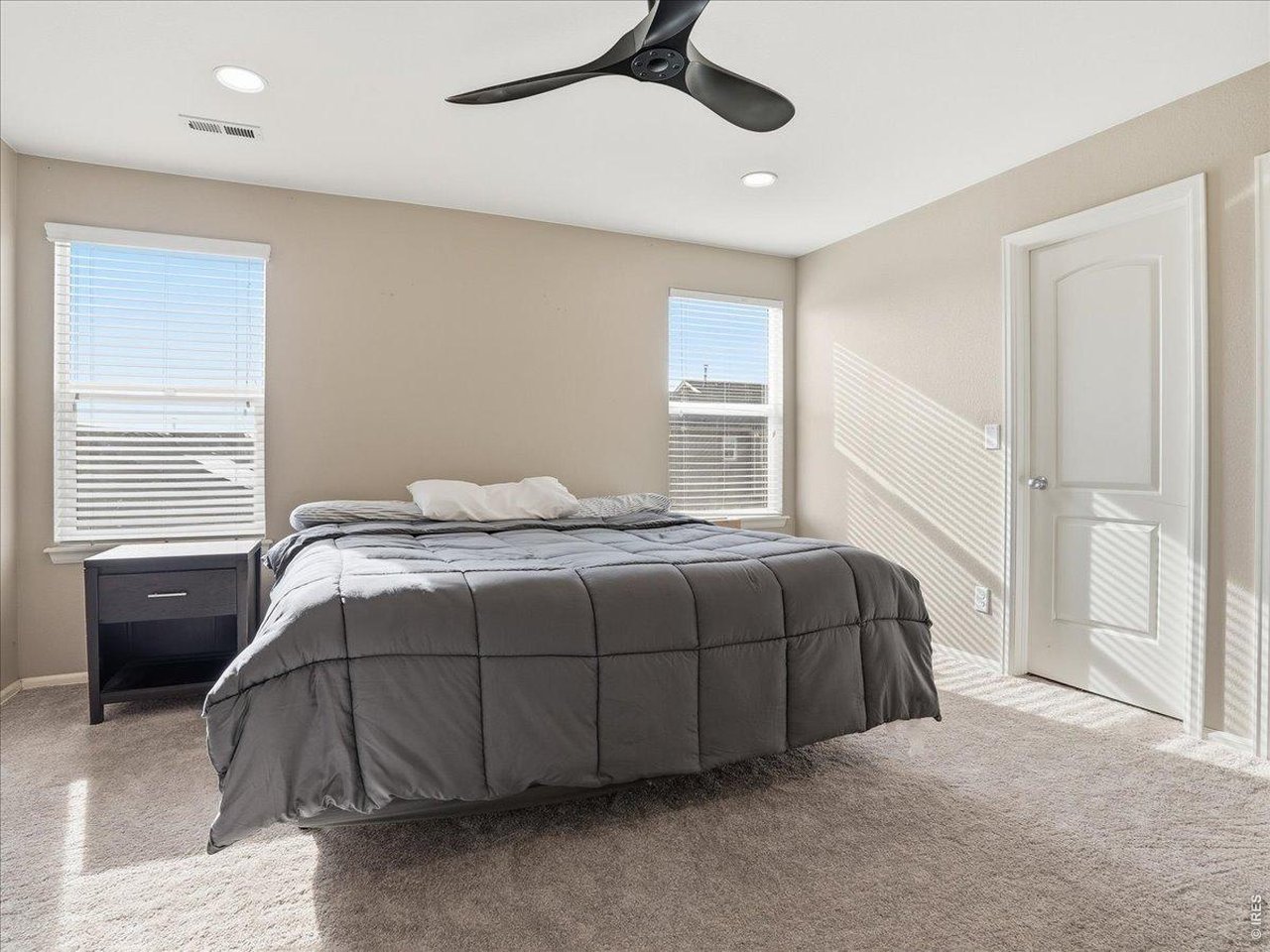 1565 Basildon Court Windsor, CO 80550 - Photo 20 of 36 a bedroom with a bed and a window