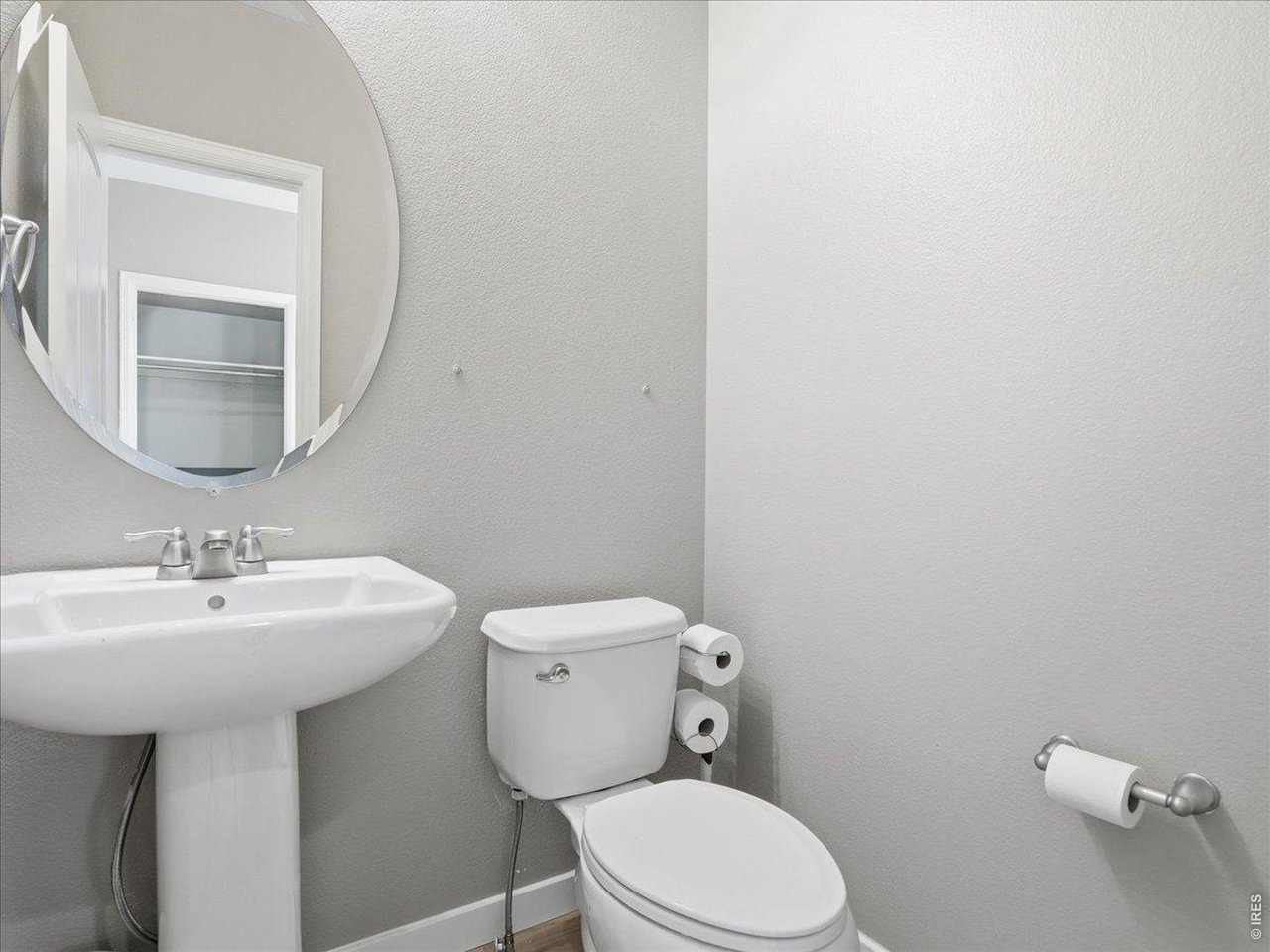 1565 Basildon Court Windsor, CO 80550 - Photo 21 of 36 a bathroom with a sink mirror and toilet