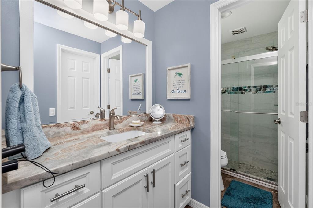 219 Caddy Road Rotonda West, FL 33947 - Photo 43 of 89 a bathroom with a granite countertop sink and a mirror