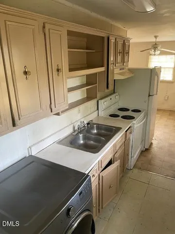 a kitchen that has a sink and a stove