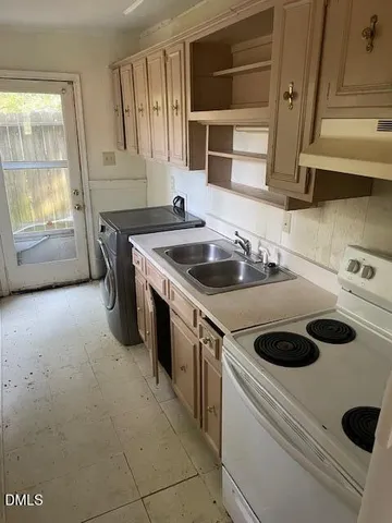 a kitchen that has a sink and a stove