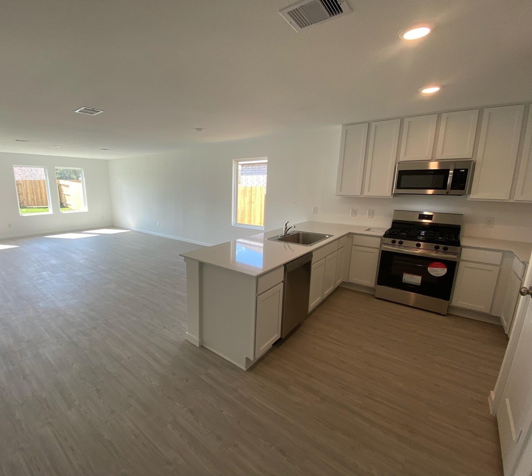 2209 Jeter Drive Bryan, TX 77807 - Photo 4 of 24 a kitchen with stainless steel appliances granite countertop a stove a sink and a refrigerator