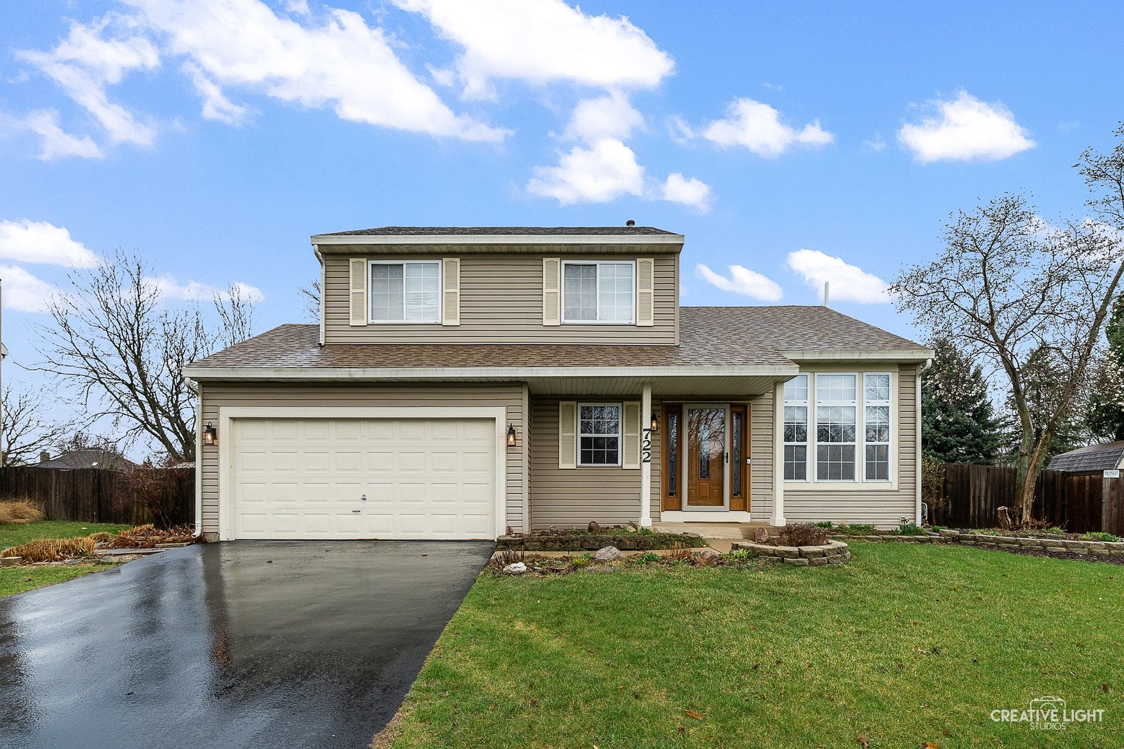 a front view of a house with a garden