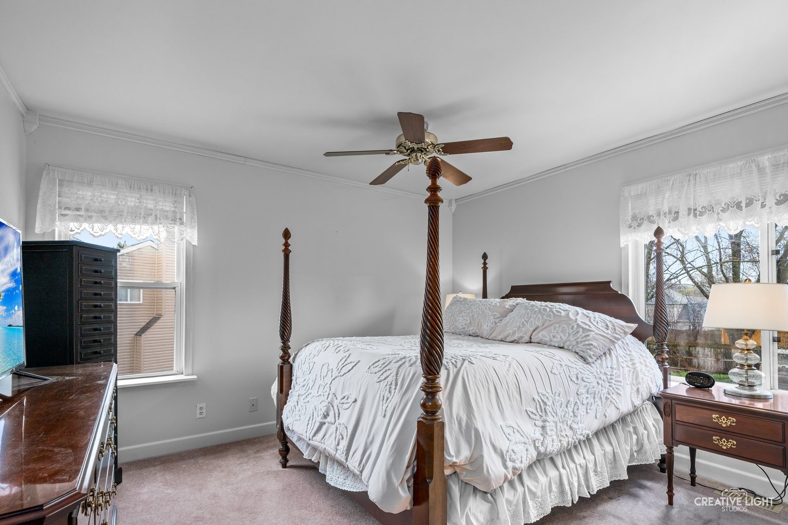 722 Burton Drive Batavia, IL 60510 - Photo 14 of 35 a bedroom with a bed and a flat tv screen on the dresser