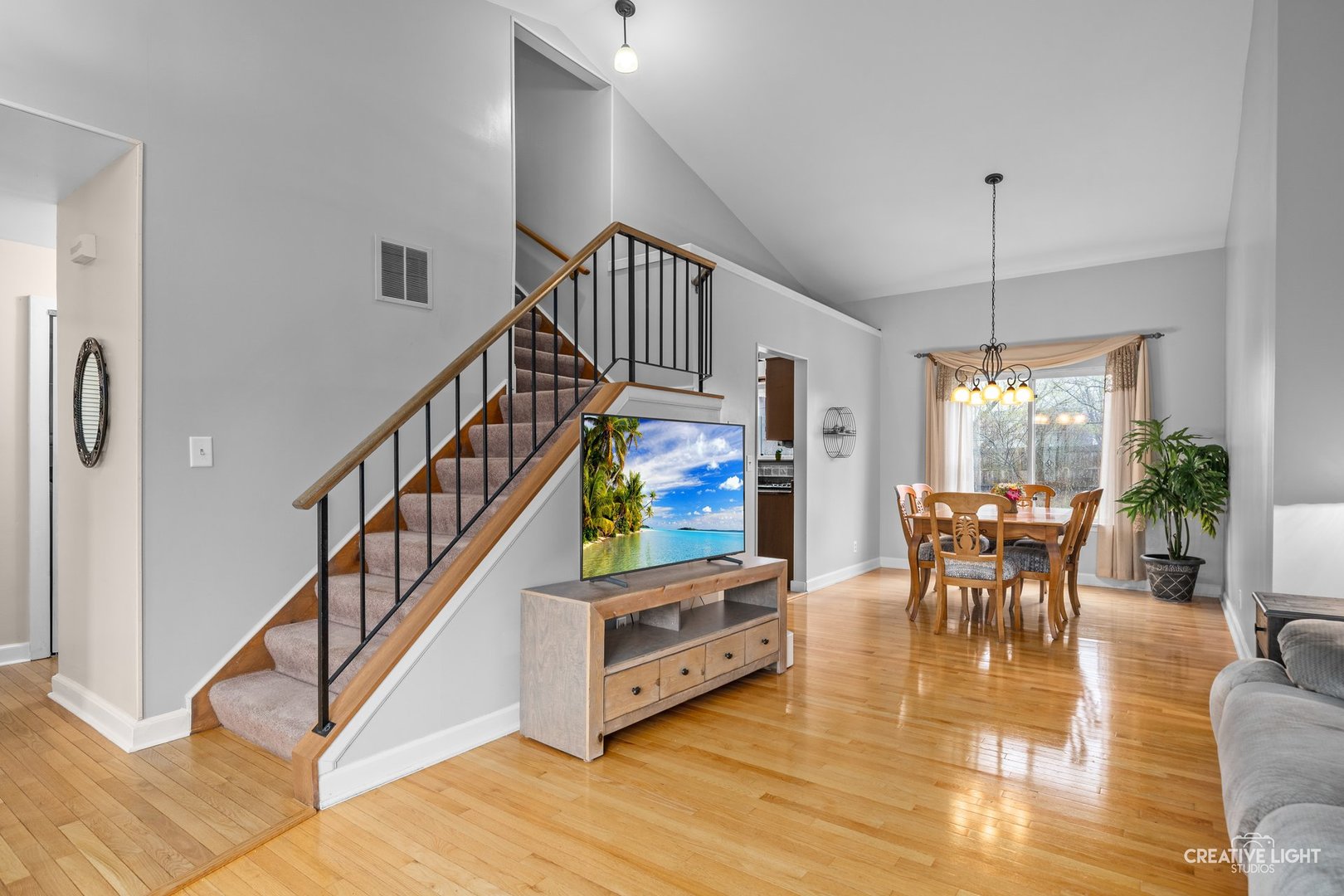 722 Burton Drive Batavia, IL 60510 - Photo 5 of 35 a dining room with furniture a chandelier and wooden floor