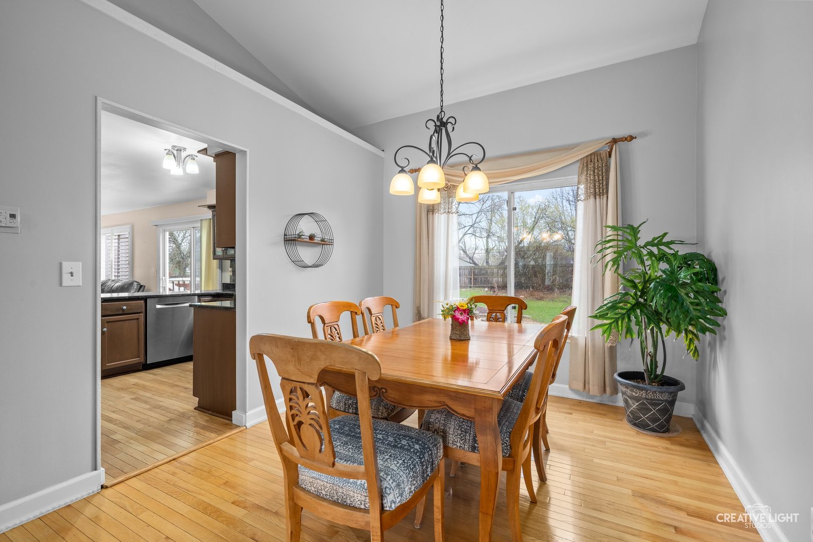 722 Burton Drive Batavia, IL 60510 - Photo 7 of 35 a dining room with furniture a chandelier and wooden floor