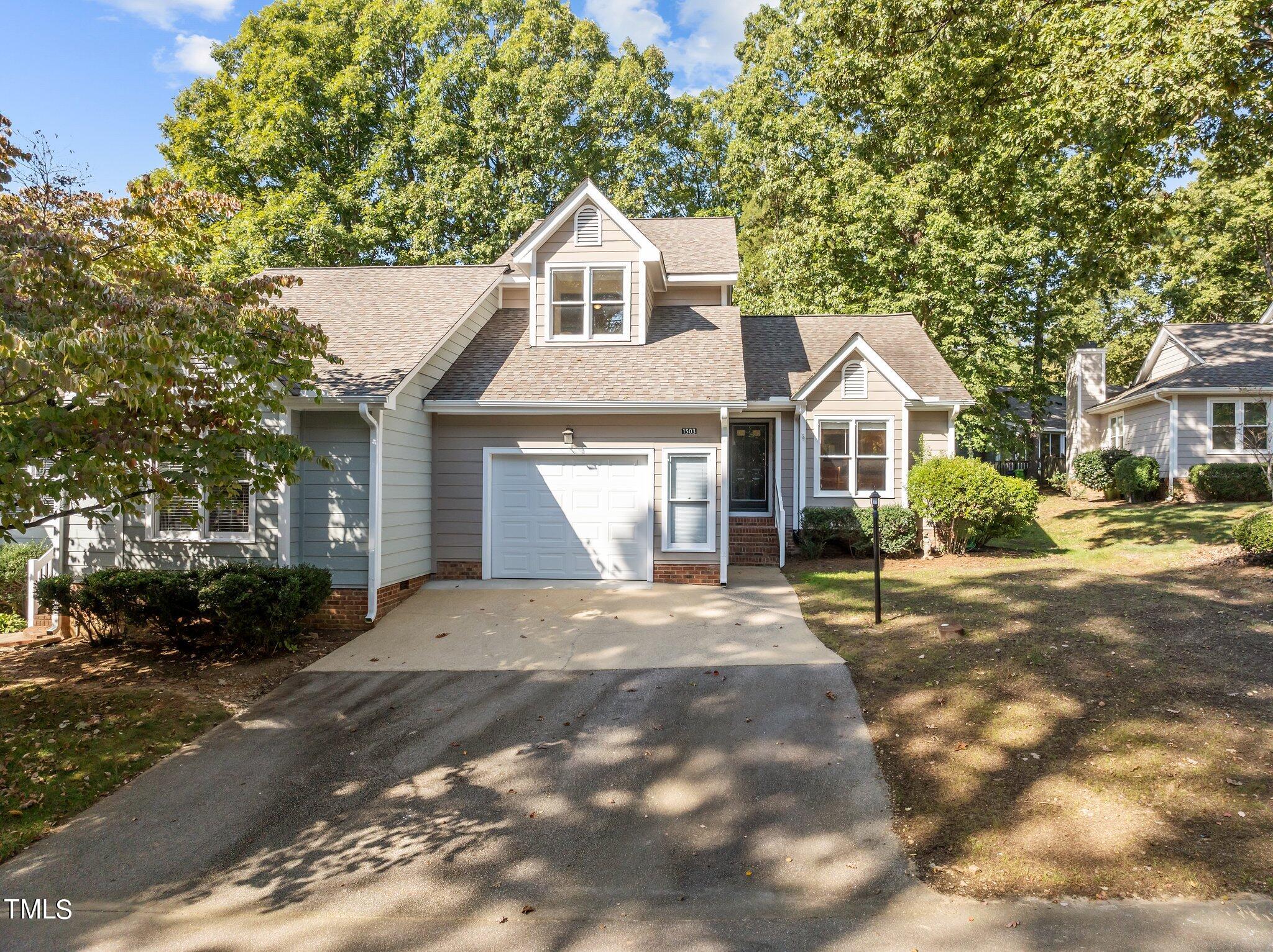 1503 Nature Court Raleigh, NC 27609 - Photo 1 of 36 a front view of a house with a yard and garage