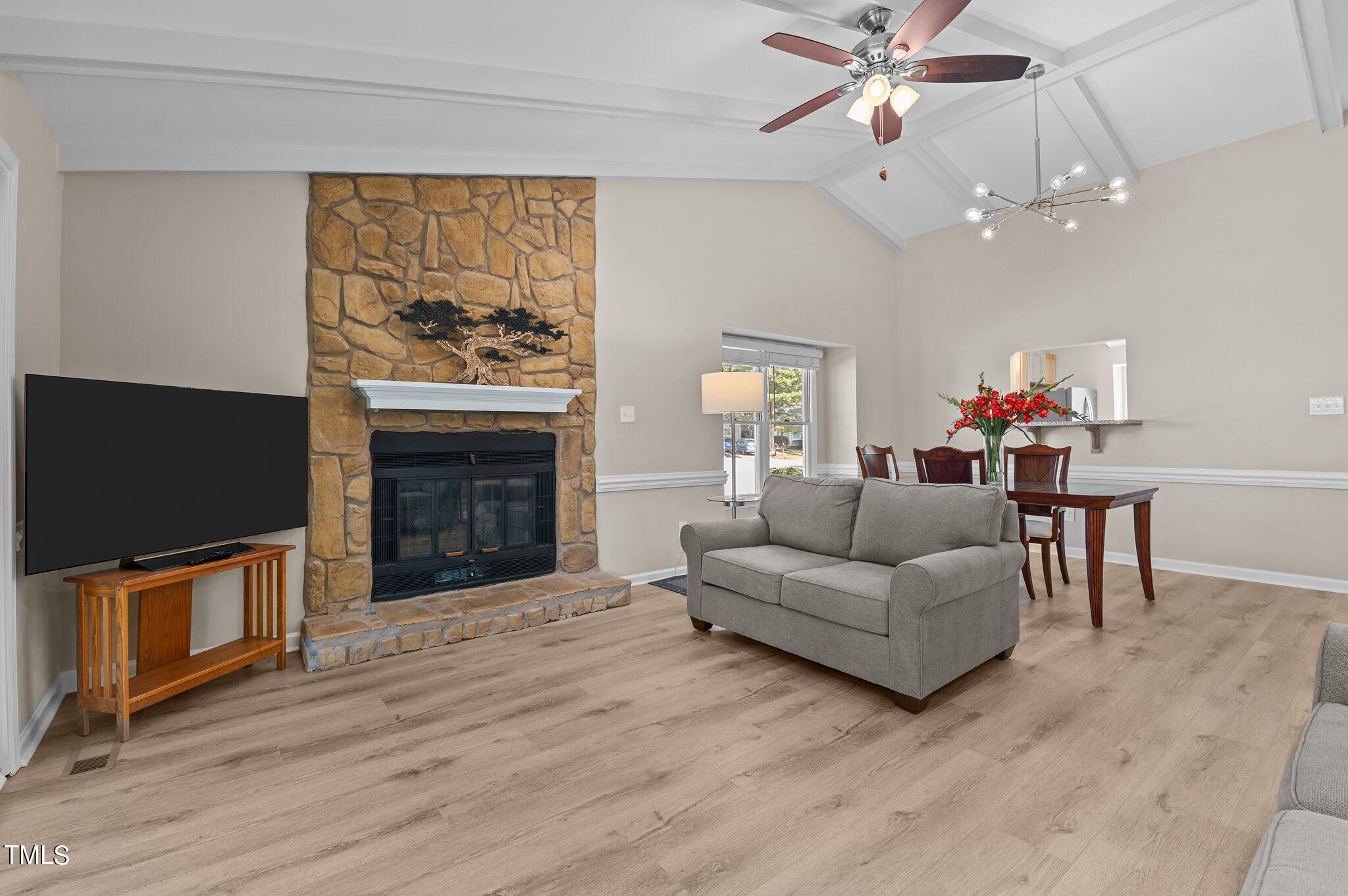1503 Nature Court Raleigh, NC 27609 - Photo 11 of 36 a living room with furniture a flat screen tv and a fireplace