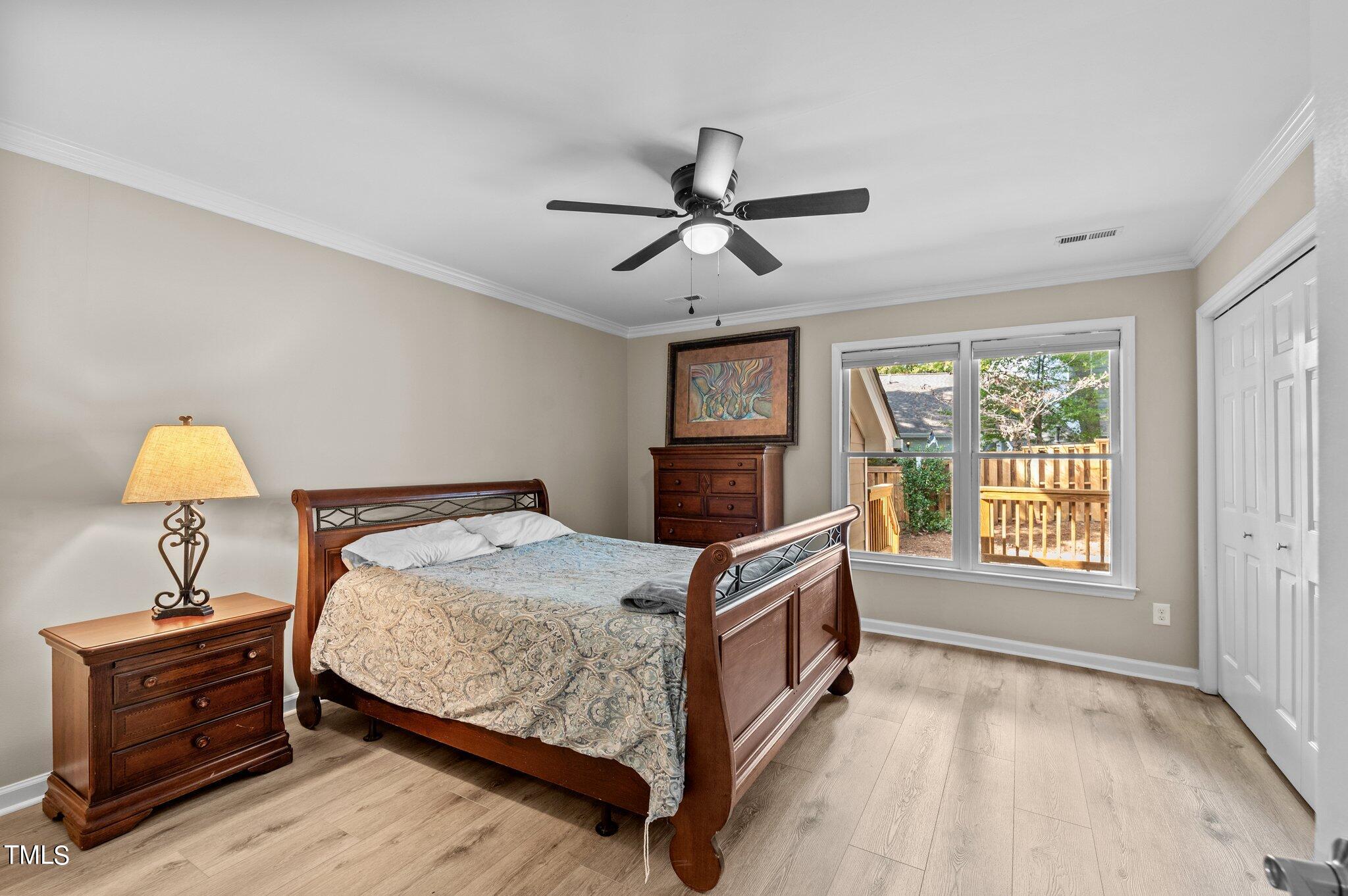 1503 Nature Court Raleigh, NC 27609 - Photo 21 of 36 a bed room with a bed and a chandelier