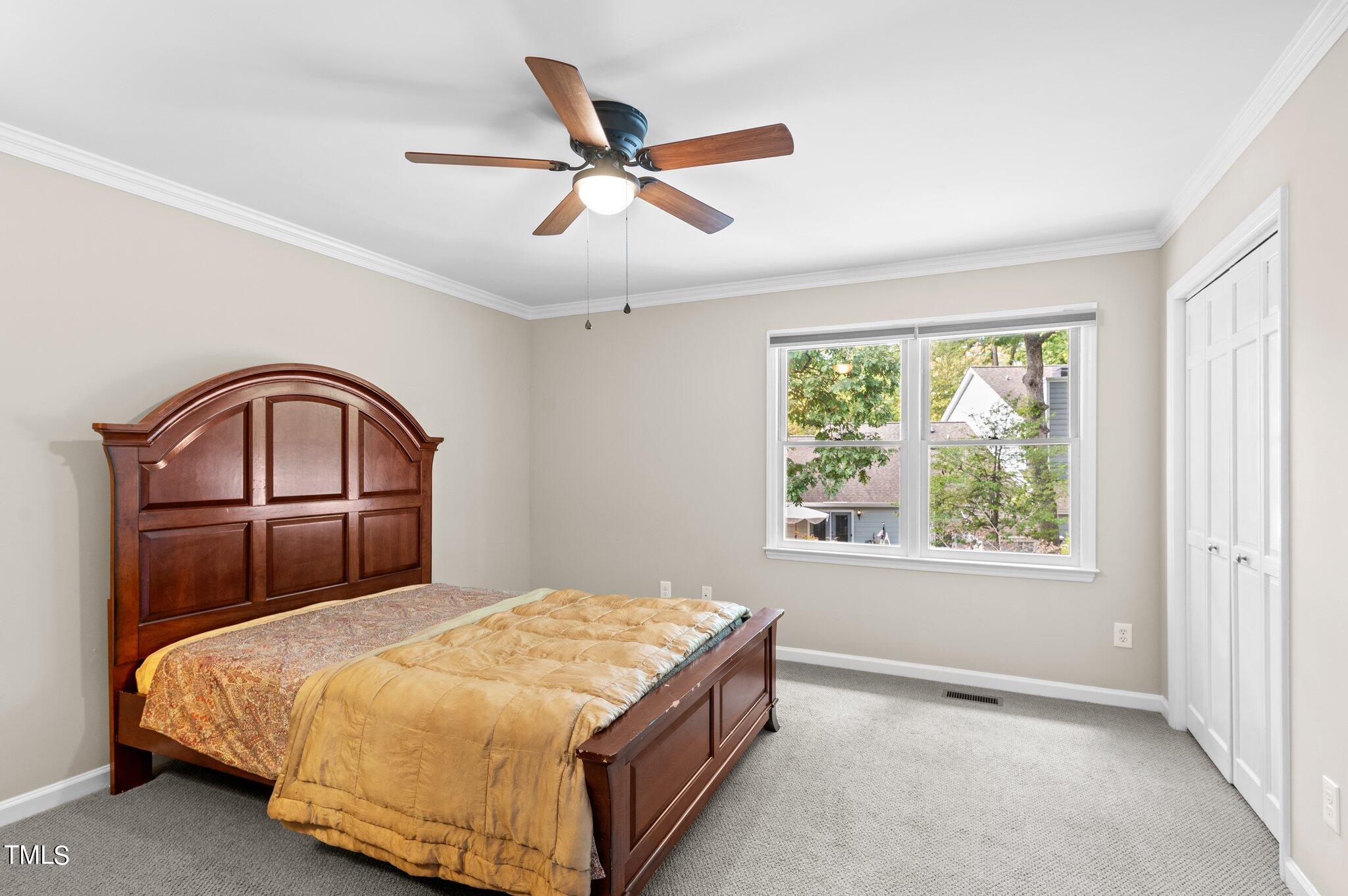 1503 Nature Court Raleigh, NC 27609 - Photo 26 of 36 a bedroom with a large bed and a window