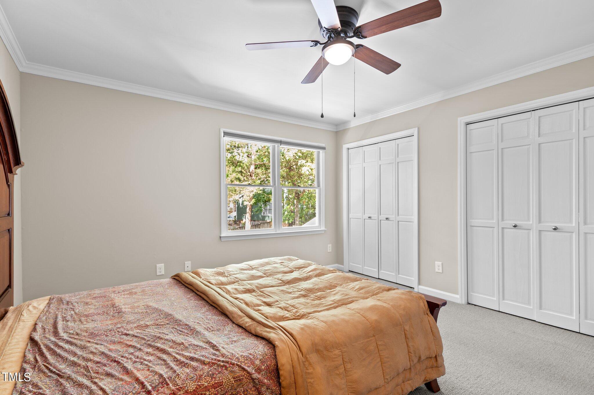 1503 Nature Court Raleigh, NC 27609 - Photo 27 of 36 a bedroom with a large bed and a chandelier