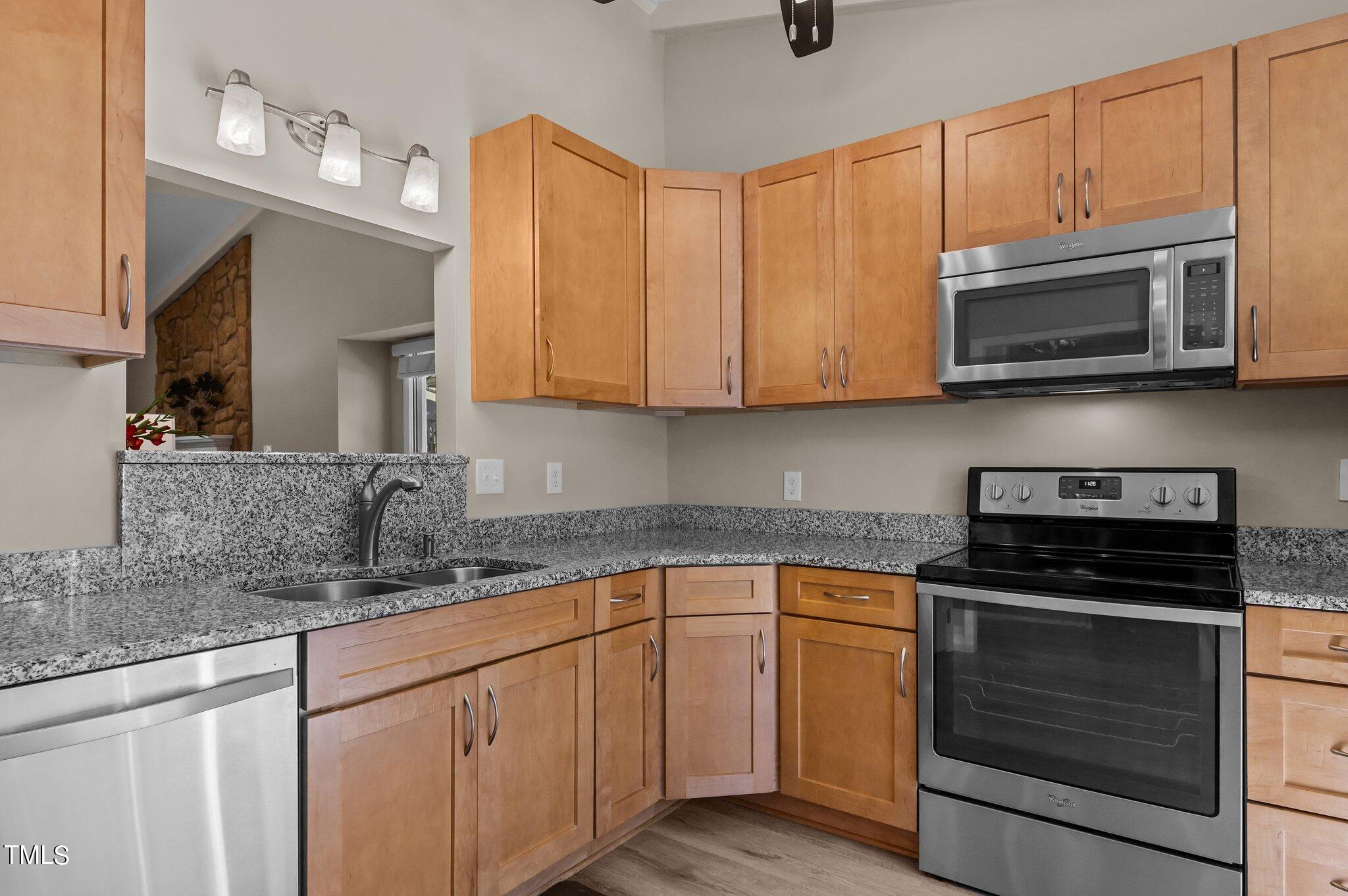 1503 Nature Court Raleigh, NC 27609 - Photo 7 of 36 a kitchen with stainless steel appliances granite countertop a stove microwave and cabinets