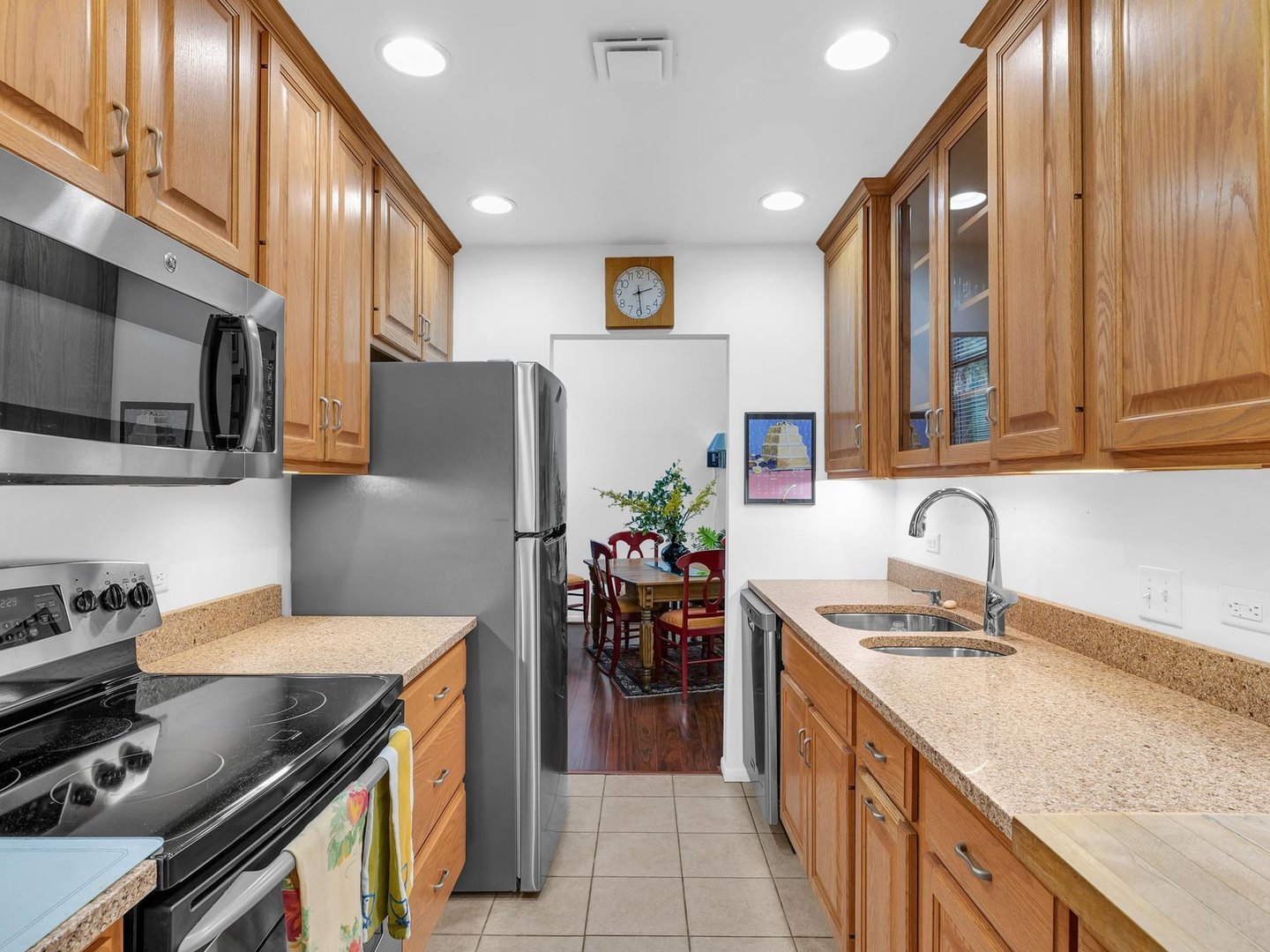 107 North Elm Street, Unit 310 Champaign, IL 61820 - Photo 14 of 34 a kitchen with stainless steel appliances granite countertop a sink stove and refrigerator