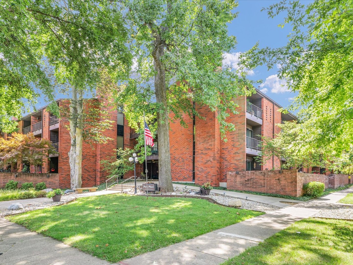 107 North Elm Street, Unit 310 Champaign, IL 61820 - Photo 2 of 34 front view of house with a yard and potted plants