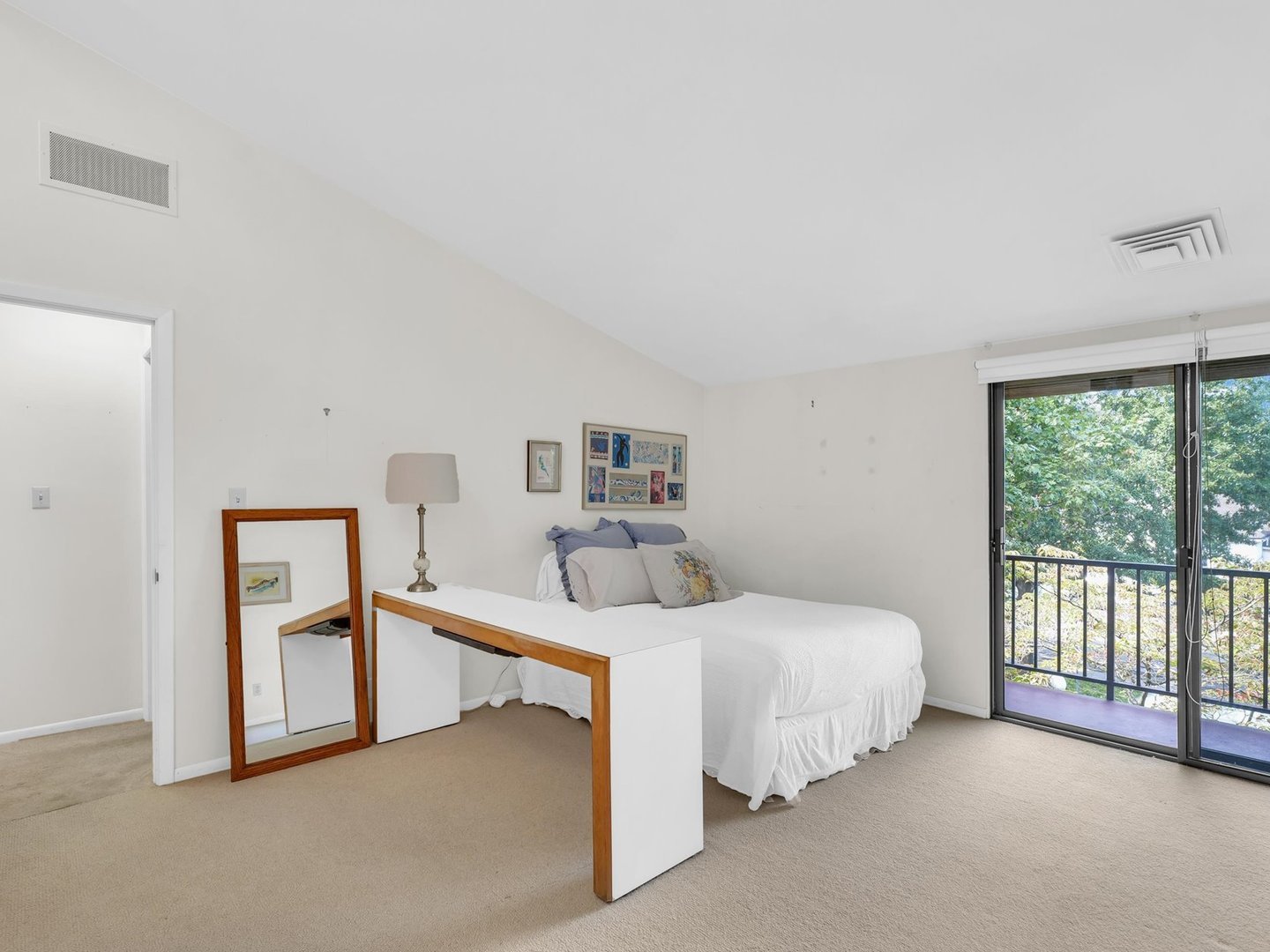 107 North Elm Street, Unit 310 Champaign, IL 61820 - Photo 21 of 34 a bedroom with a bed and a large window