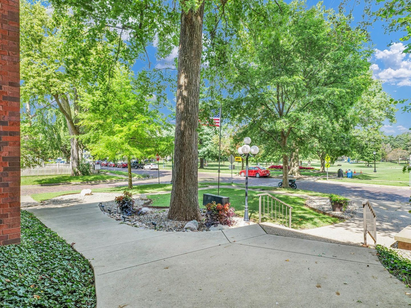 107 North Elm Street, Unit 310 Champaign, IL 61820 - Photo 31 of 34 a street view with sitting space and trees