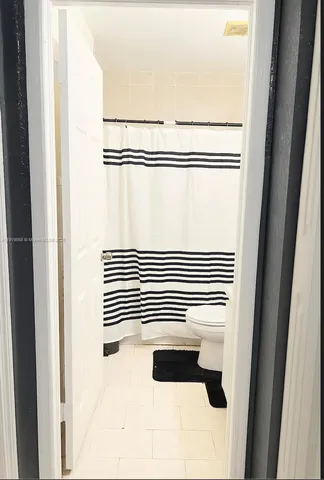 a bathroom with a shower curtain
