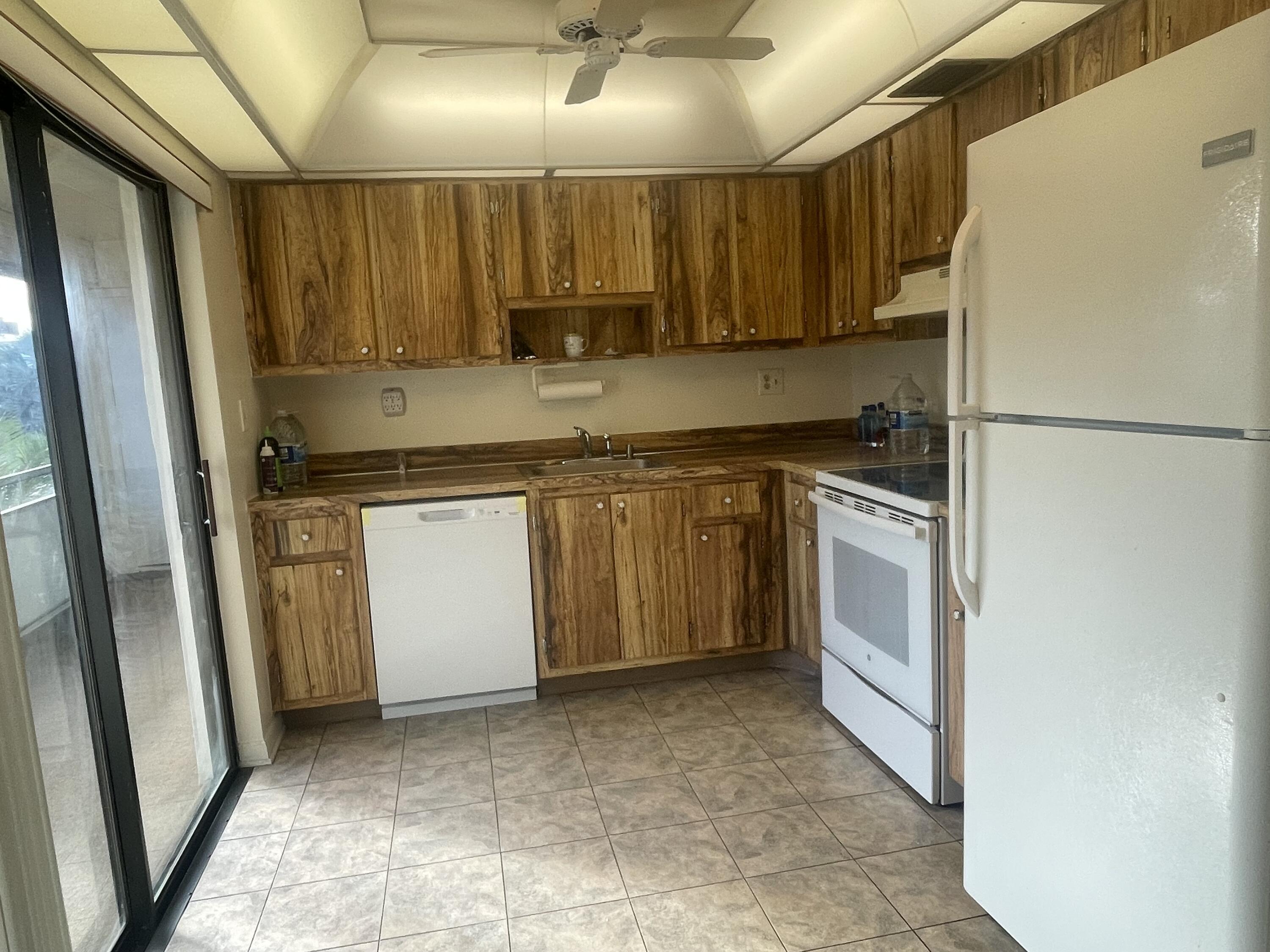 83 Capri B, Unit 83 Delray Beach, FL 33484 - Photo 1 of 26 a kitchen with a sink a refrigerator and cabinets