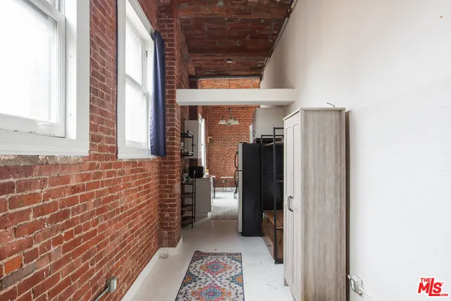 a view of hallway with a door and wooden floor