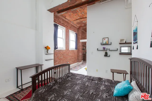 a bedroom with furniture and a window