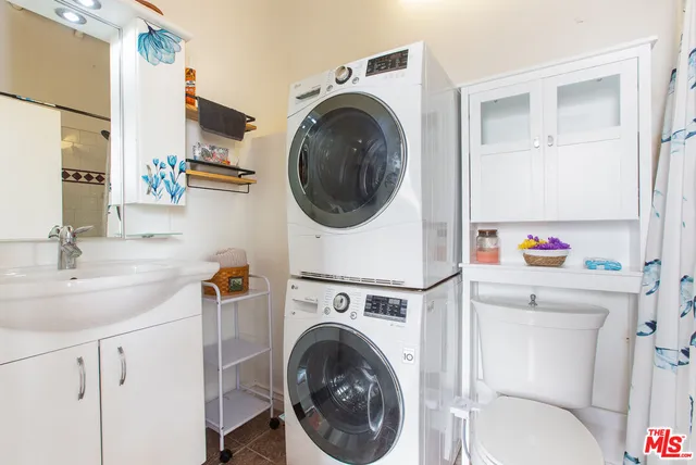 a utility room with sink dryer and washer