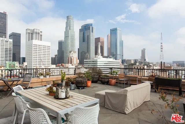 a living room with furniture and floor to ceiling windows