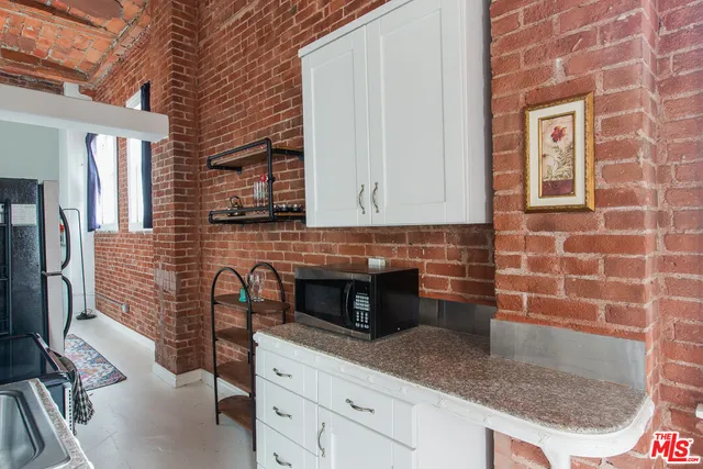 a kitchen with granite countertop a sink and a stove