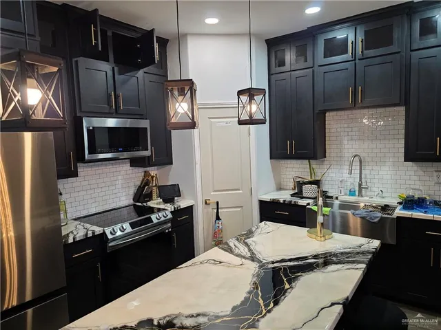 a kitchen with a refrigerator stove and microwave
