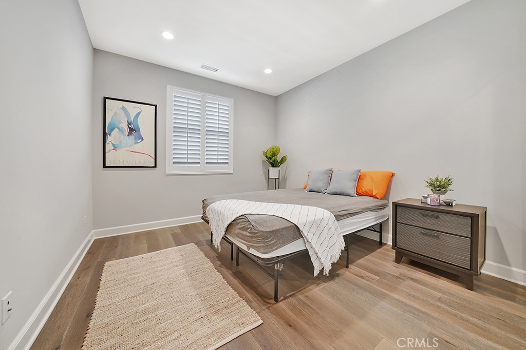 125 Okra Irvine, CA 92618 - Photo 30 of 39 a bedroom with a bed and a painting on the wall
