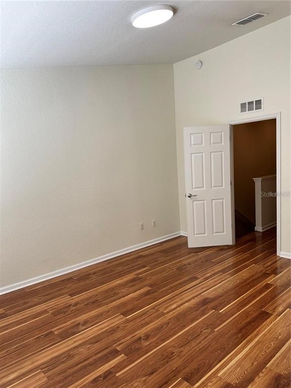 4500 Southwest 52nd Circle, Unit 106 Ocala, FL 34474 - Photo 13 of 30 a view of empty room with wooden floor