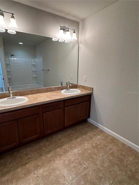 4500 Southwest 52nd Circle, Unit 106 Ocala, FL 34474 - Photo 14 of 30 a bathroom with a sink and a mirror