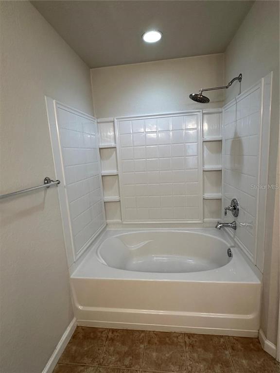 4500 Southwest 52nd Circle, Unit 106 Ocala, FL 34474 - Photo 15 of 30 a bathroom with a bath tub and shower