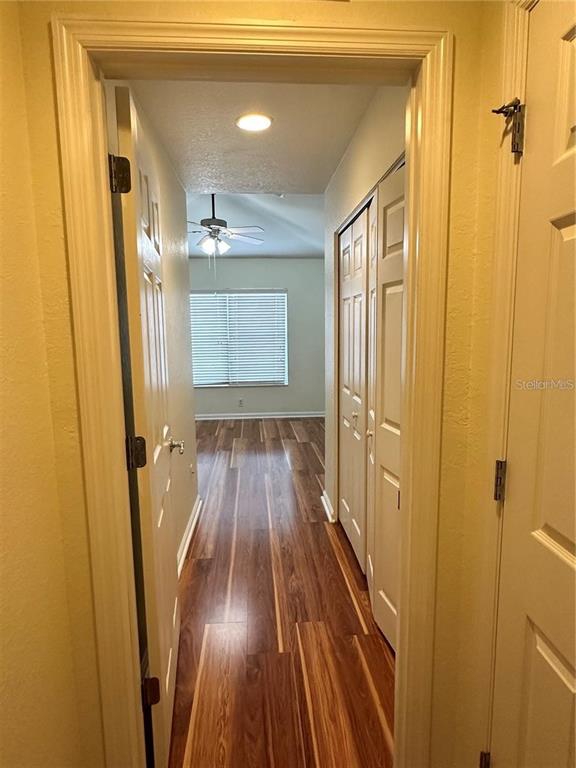 4500 Southwest 52nd Circle, Unit 106 Ocala, FL 34474 - Photo 18 of 30 a view of a hallway with wooden floor and staircase