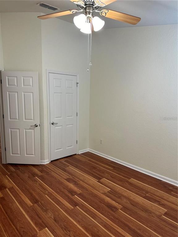 4500 Southwest 52nd Circle, Unit 106 Ocala, FL 34474 - Photo 20 of 30 a view of empty room with wooden floor and fan