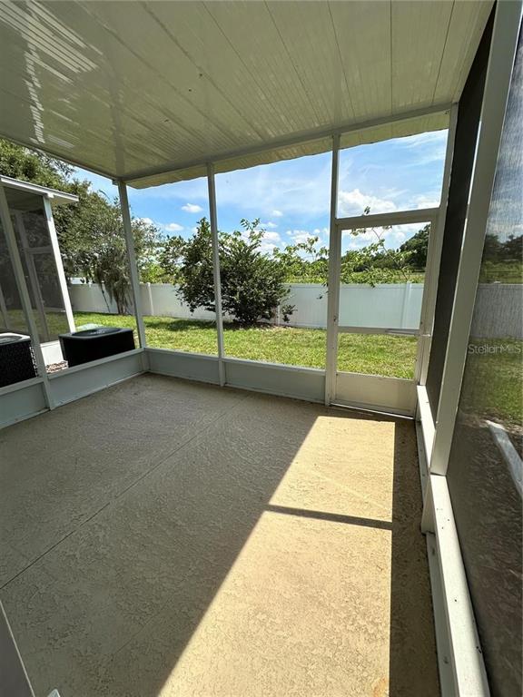 4500 Southwest 52nd Circle, Unit 106 Ocala, FL 34474 - Photo 29 of 30 a view of porch with a table under an umbrella