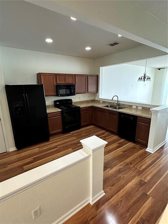 4500 Southwest 52nd Circle, Unit 106 Ocala, FL 34474 - Photo 4 of 30 a kitchen with stainless steel appliances kitchen island granite countertop a sink dishwasher stove and refrigerator
