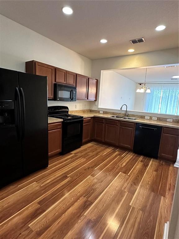 4500 Southwest 52nd Circle, Unit 106 Ocala, FL 34474 - Photo 5 of 30 a large kitchen with stainless steel appliances granite countertop a sink counter space and cabinets