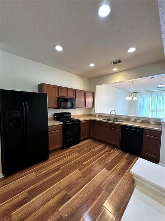 4500 Southwest 52nd Circle, Unit 106 Ocala, FL 34474 - Photo 6 of 30 a kitchen with stainless steel appliances kitchen island granite countertop a refrigerator and a stove top oven