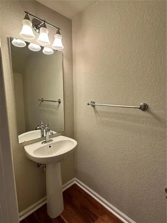 a bathroom with a sink a mirror and vanity