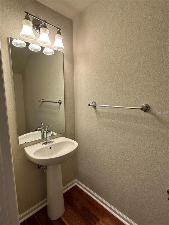 4500 Southwest 52nd Circle, Unit 106 Ocala, FL 34474 - Photo 10 of 30 a bathroom with a sink a mirror and vanity