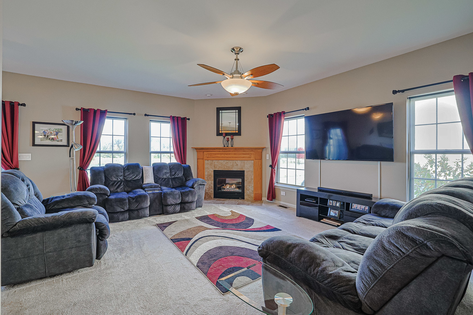 1242 Prairie View Parkway Cary, IL 60013 - Photo 11 of 36 a living room with furniture a fireplace and a large window